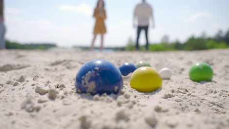 Close-up-view-of-some-colorful-petanque-balls-on-the-beach-on-a-sunny-day