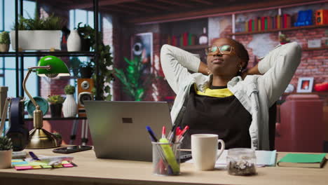 woman watching movies at home on laptop, drinking coffee