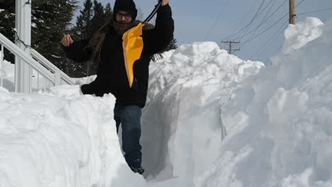 man removing snow off walkway