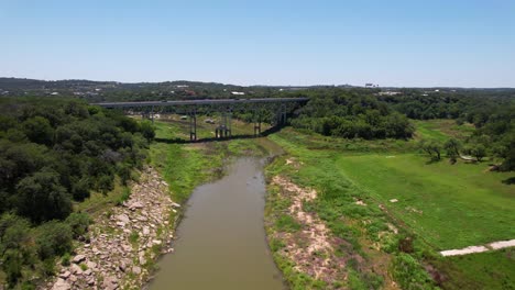 aerial footage of the pedernales river bridge highway 71 in spicewood texas