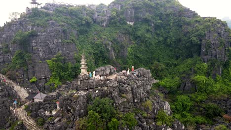 hang mua viewpoint with pagoda with limestone cliffs in background