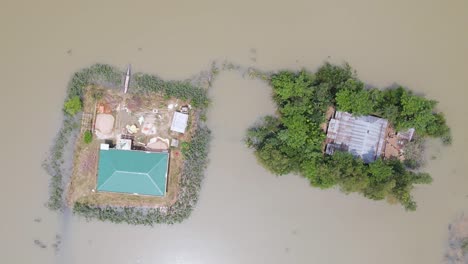 top down aerial view of submerged homes in a flooded rural bangladesh village