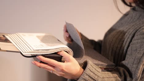 close-up of a person holding a fabric sample catalog