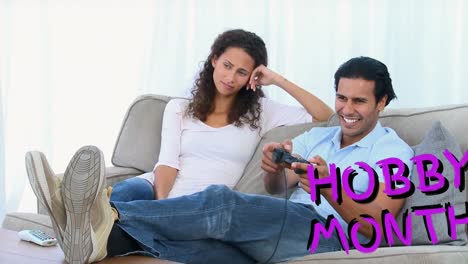 Animation-of-hobby-month-text-over-couple-using-game-console