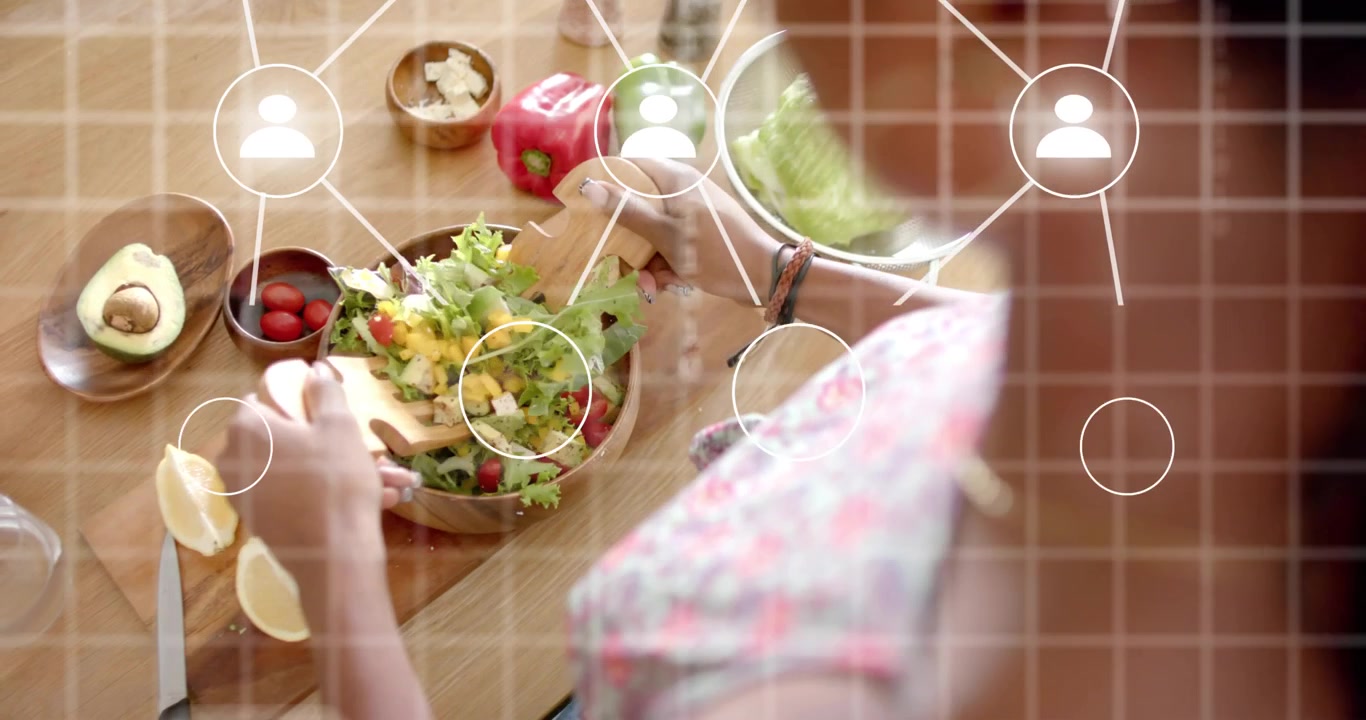 woman home cook preparing fresh salad on wooden countertop and activating tech grid network overlay