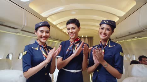 cabin crew clapping hands in airplane