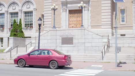 cars driving by the front of the bangor public library