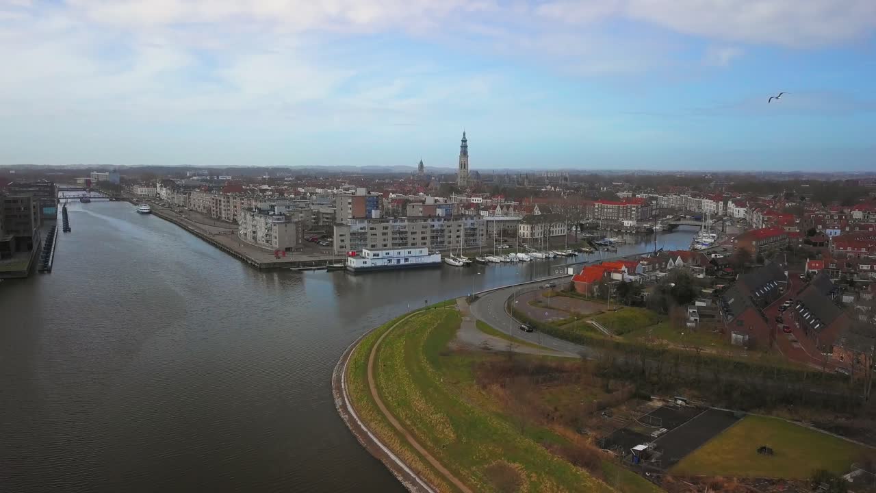 The historical city of Middelburg with in the foreground a canal and industrial area. Aerial shot