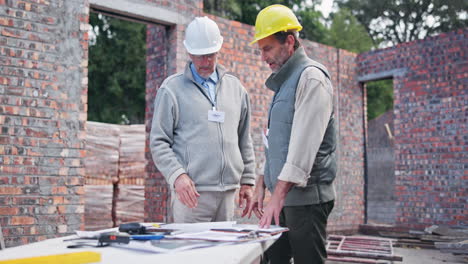 construction workers discussing plans at a building site