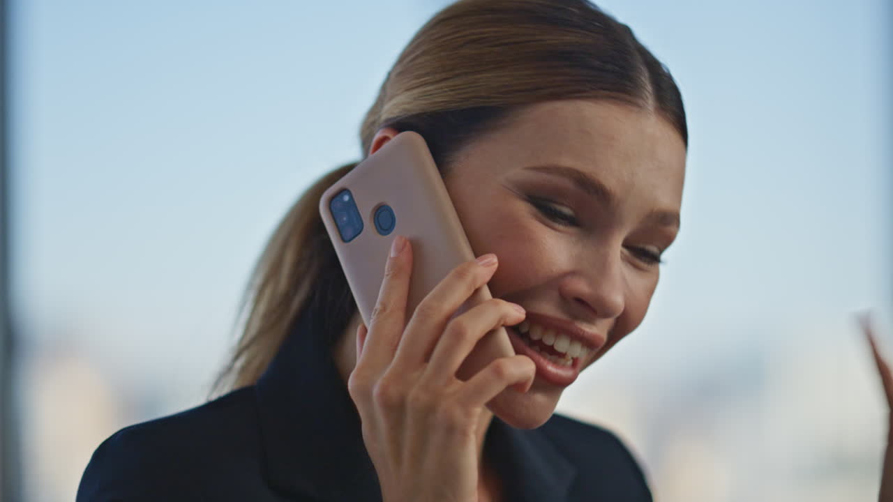 Happy worker gossiping cell in office closeup. Attractive boss woman speaking