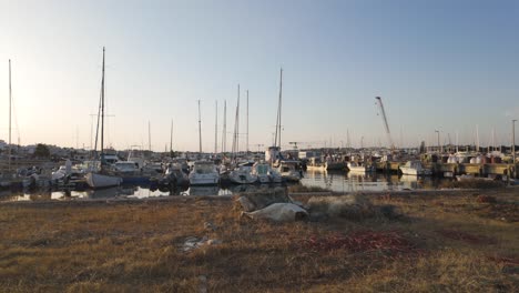 fishing nets drying on the shore with moored boats in lagos, a city in algarve, portugal
