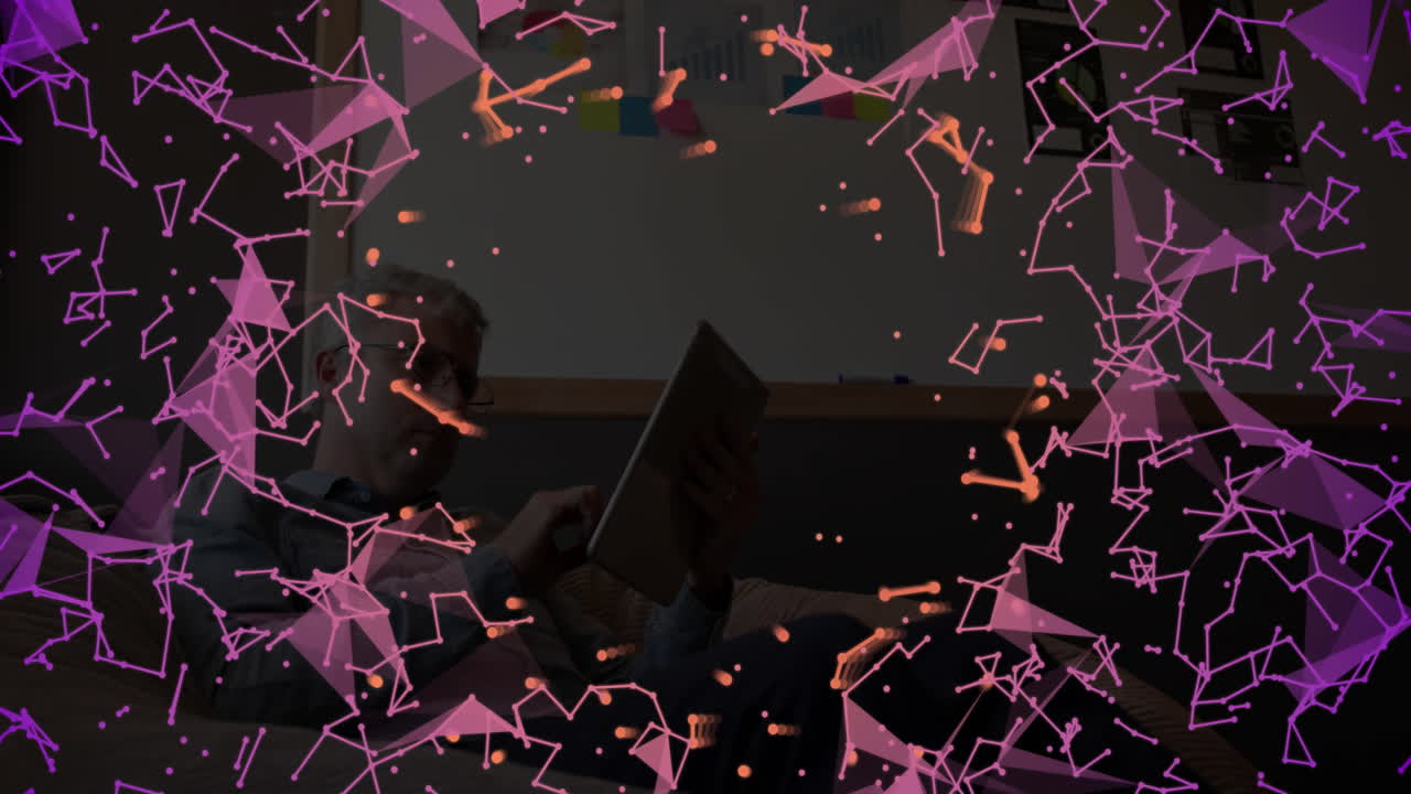 Mid-adult man interacting with tablet in office lounge, displaying glowing digital technology nodes