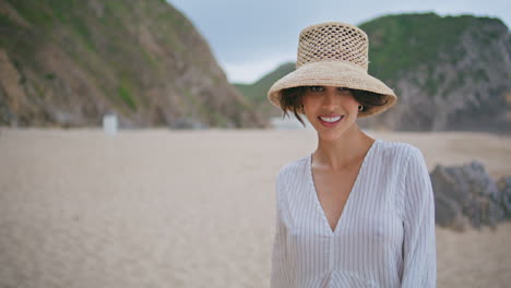 carefree woman spinning beach on summertime. smiling travel girl looking camera