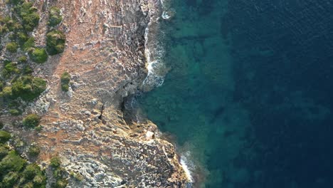 crystal clear sea at the rocky shore near sa coma bay in mallorca spain