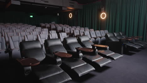 movie cinema with modern luxurious leather recliner seats and dim lights, 4k