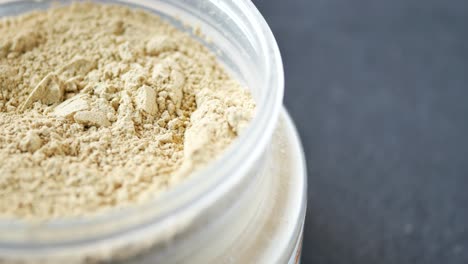 beige powder in a clear container