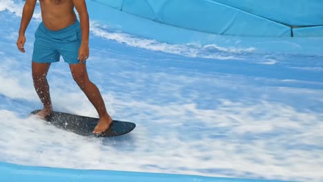 man surfing an artificial wave in a surf park