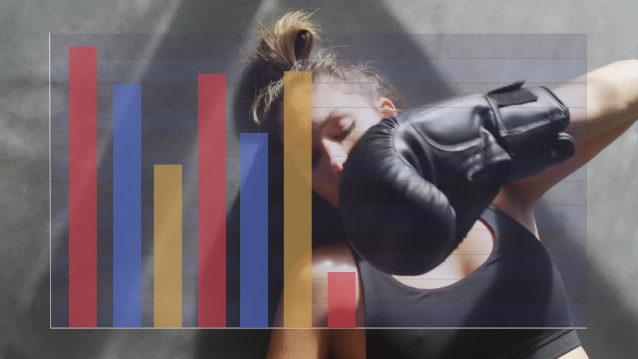 animación de diagrama sobre mujer caucásica acostada con guantes de boxeo en el gimnasio