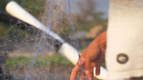 hands shaking out a fishing net