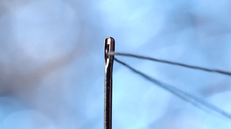 Threading a needle in macro scale