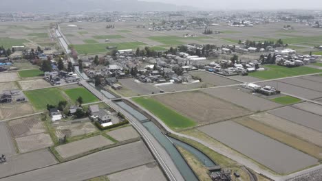 aerial view of agricultural farming fields in azumino countryside, japan. dolly forward