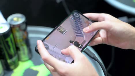 a visitor plays videogame on a smartphone during