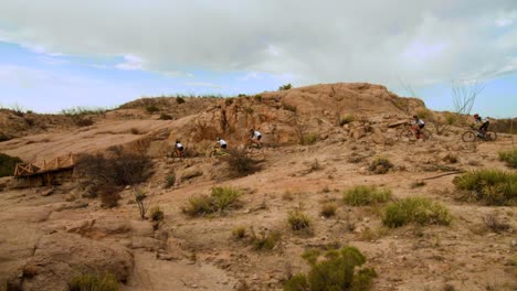 cyclist people in line formation on a bicycle race in the desert mountains