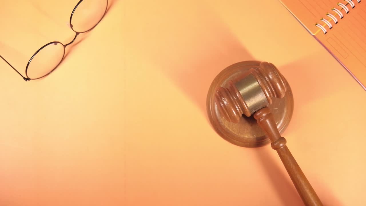 Gavel, glasses and notepad on a desk