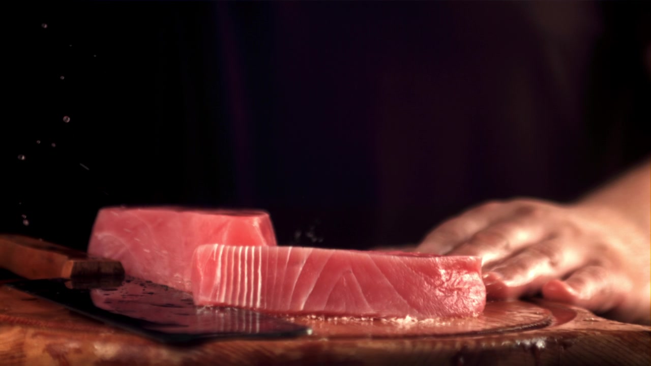 Slow Motion of Fresh Tuna Steak Falling onto Cutting Board