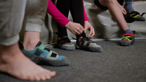 boys and girl putting climbing boots on