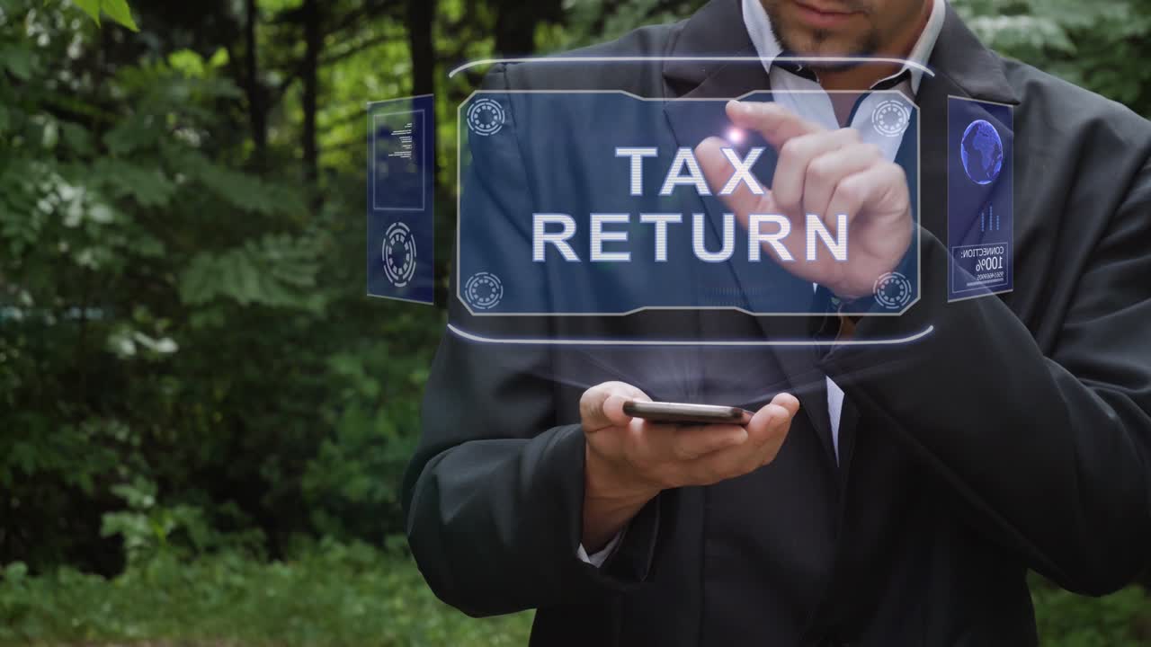 Businessman uses hologram with text Tax Return