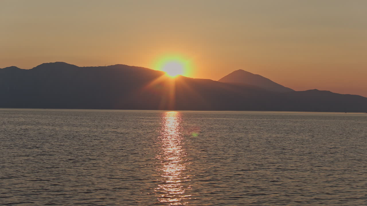 view from a yacht of a greek island at sunrise