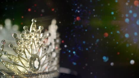 confetti falls from above as the miss beauty pageant winner is announced - jeweled crown on a turntable display