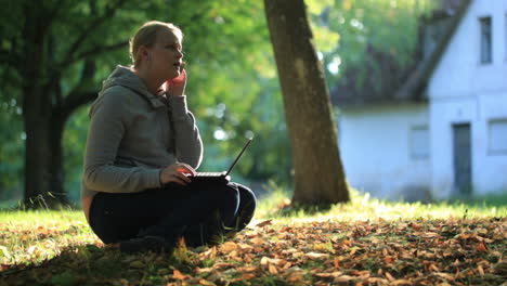 Young-woman-sitting-on-the-ground-outdoors