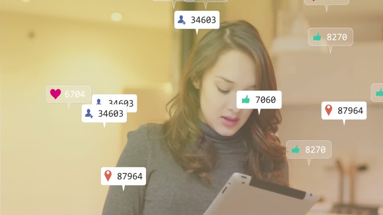 Content creator reading tablet in office, tapping screen and tracking floating social media metrics