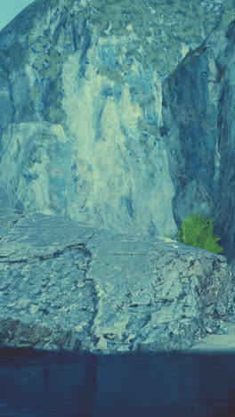 a close up of a rocky cliff by the sea