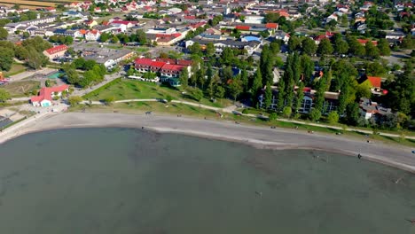 Flying-On-Coastal-Road-And-Town-In-Neusiedler-See,-Burgenland,-Austria