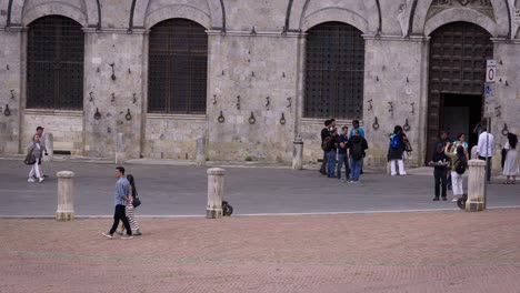 tourists visiting a historic stone building in italy