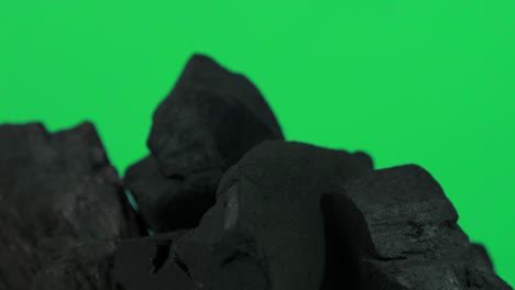 charcoal wooden. natural wood or traditional black charcoal looping on turnable. blue or green screen background with color led light. shot on static.  charcoal for bbq grill cooking. black charcoal.