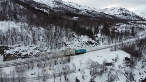 arctic norwegian landscape close to narvik establishing shot with road and trucks in focus