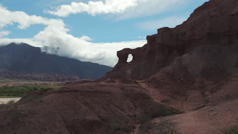 Las-ventanas-through-a-video-drone-shot-in-a-fast-pace-showing-it-beauty-and-revealing-a-brook-on-the-left-side-of-the-rock-formations