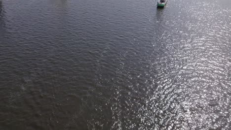 Flying-over-sailing-boats-at-Friesland-during-a-summer-day,-aerial