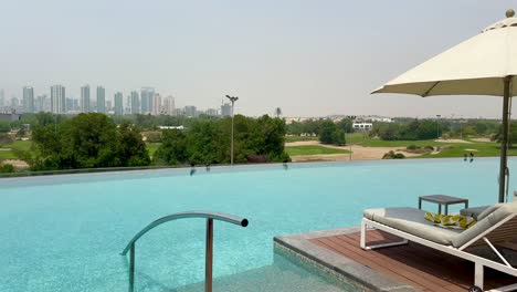 large outdoor pool with skyscrapers backdrop at vida hills, dubai