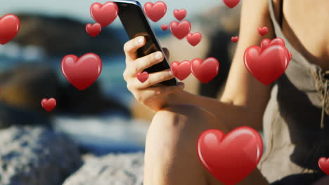 woman sitting near the beach texting 4k