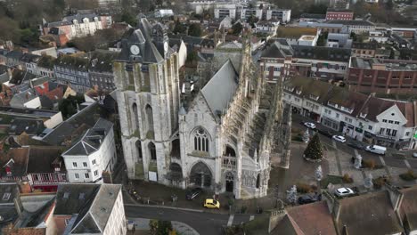 old french gothic cathedral in small town, normandy france, aerial drone