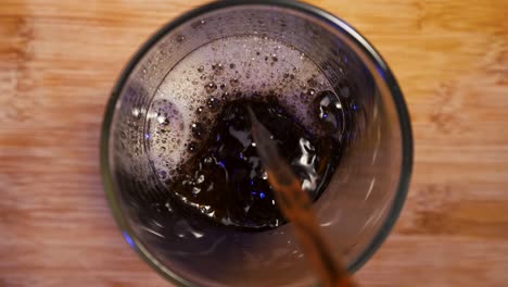 Dark roast coffee pouring into glass, creating a rich and inviting mood