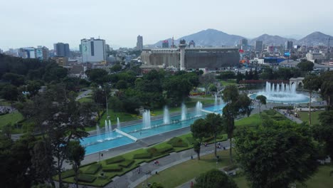 Drone-flies-upwards-above-a-water-park-full-of-fountains-called-the-"The-Magic-Water-Circuit"-which-the-world-record-for-the-largest-fountain-complex-in-the-world