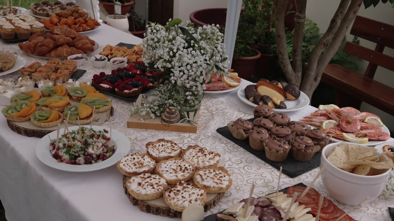 lavish buffet table filled with desserts, pastries, seafood, and appetizers