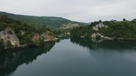 low angle aerial forward over veliko plivsko lake in bosnia and herzegovina