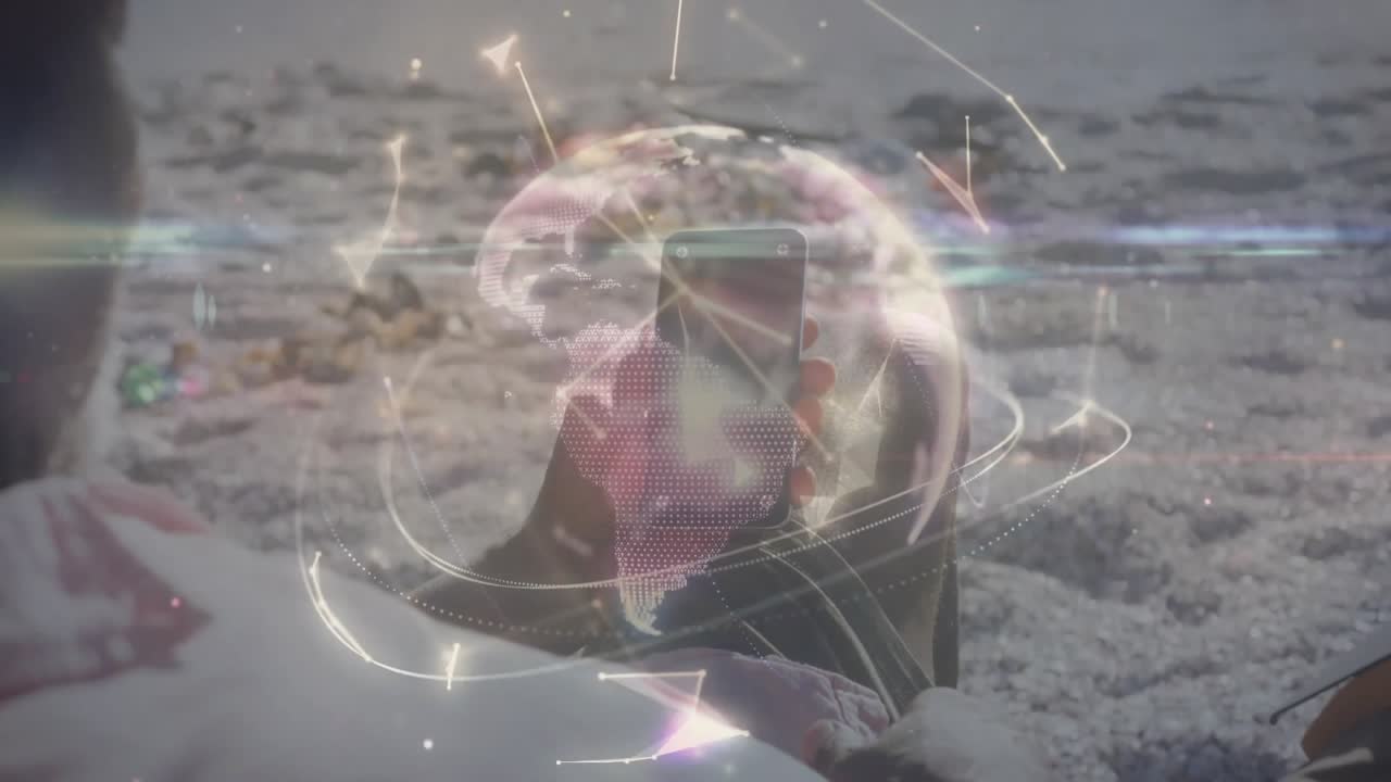 Propping smartphone against leg, man reclining on shore visualizing tech network data around device